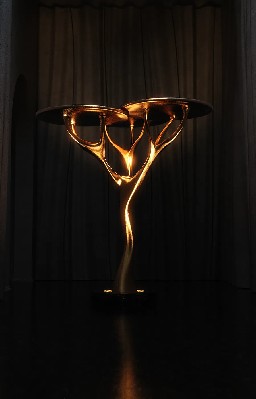 Night hallway with sculptural Acacia lamp in gold