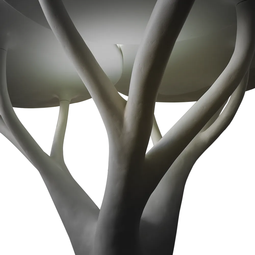 Detailed view of the top of the sculptural Acacia lamp in white with light effect