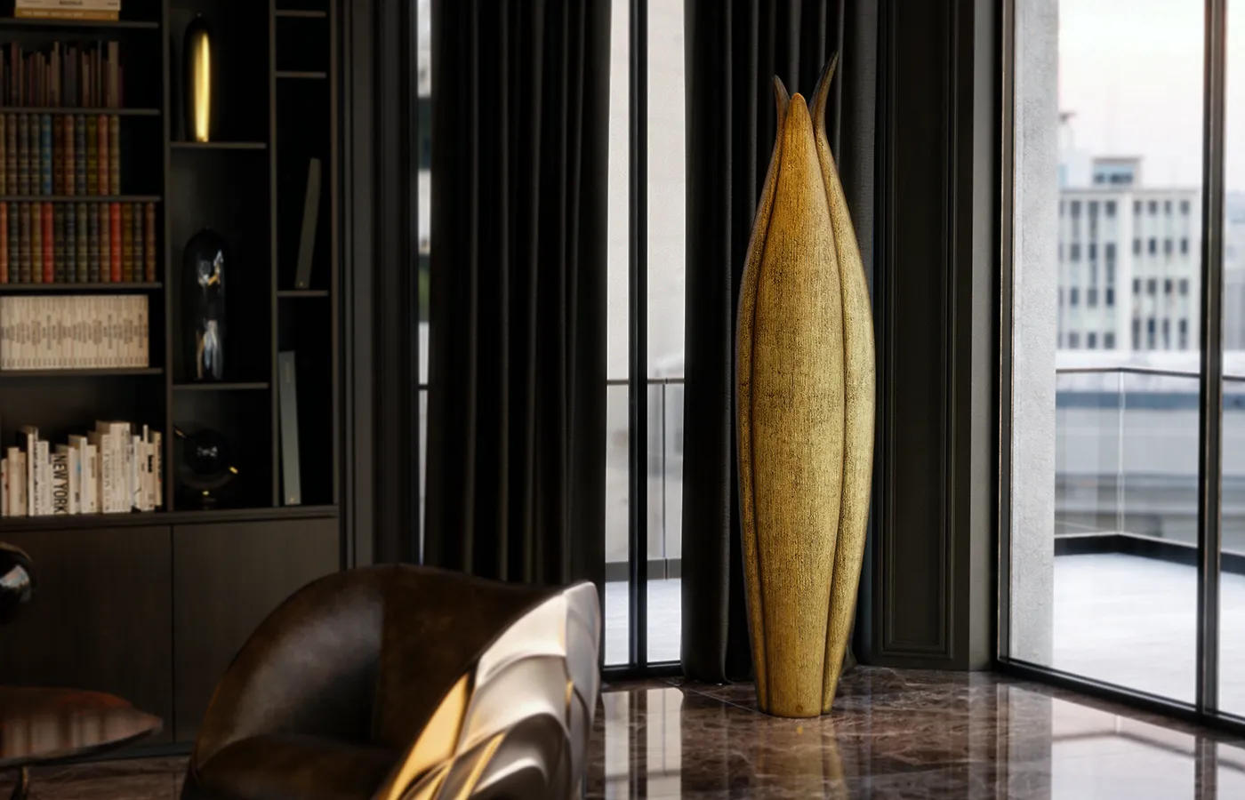 Library setting with Agave planter in aged gold leaf finish by the window