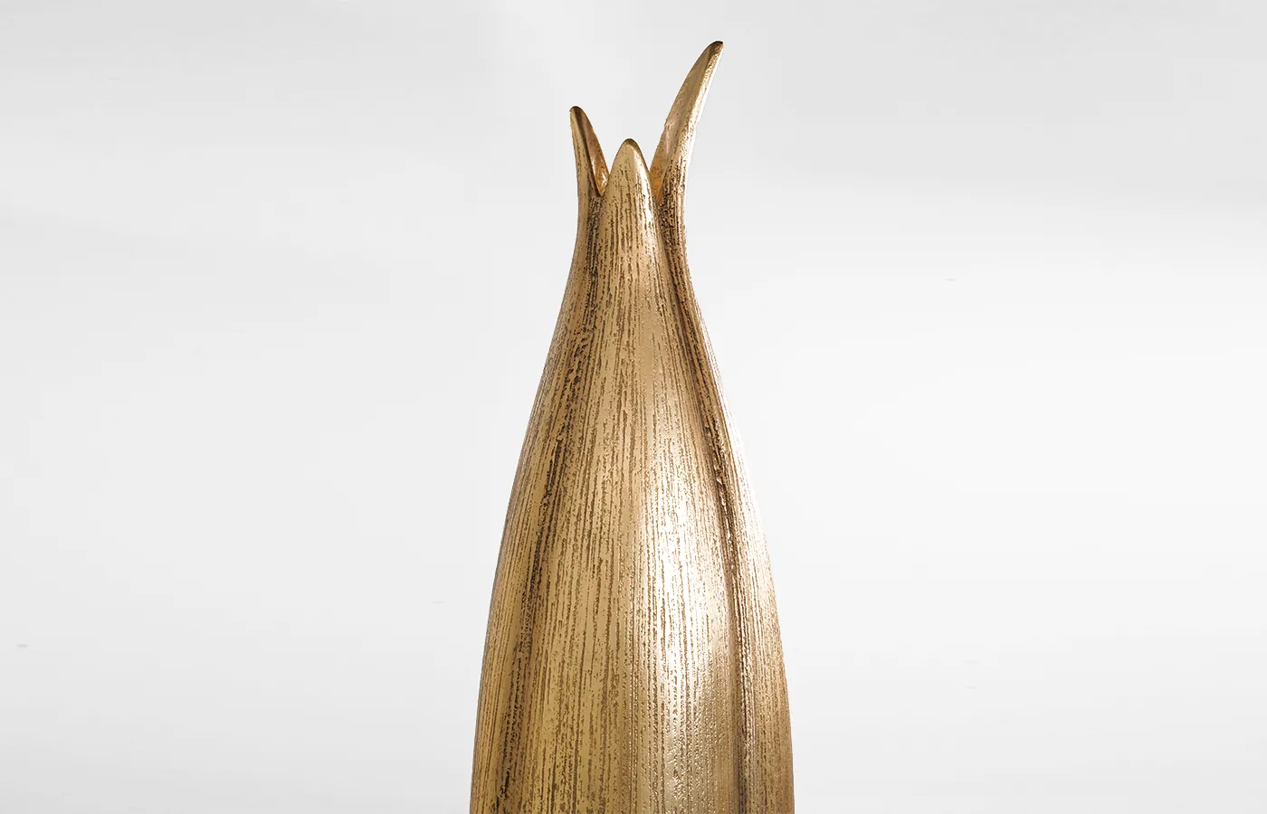 Close-up view of Agave planter with aged gold leaf finish and stripes texture