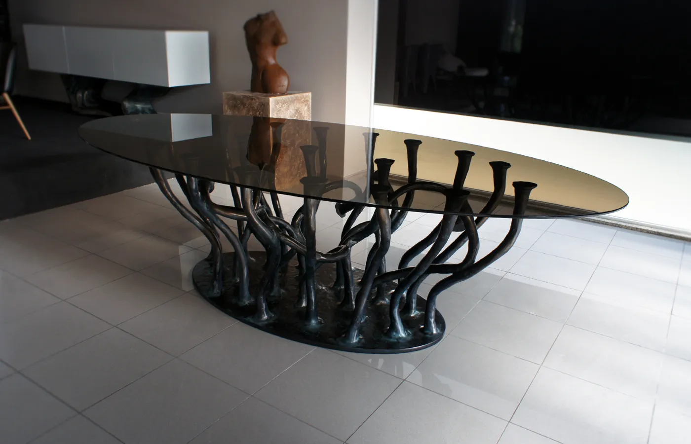 Allana dining table in bronze color with glass top in showroom setting
