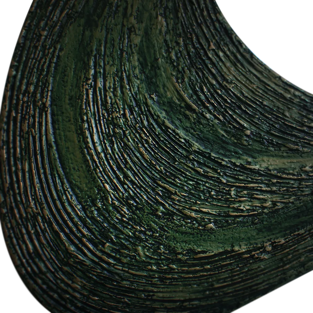 Close-up view of the textured green finish of the Atlas mirror