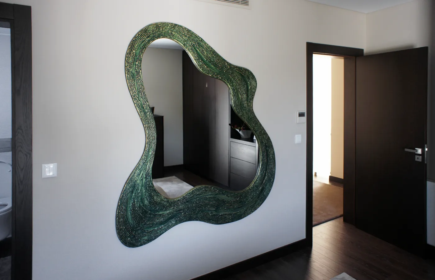 Suite bedroom with Atlas mirror in textured green finish