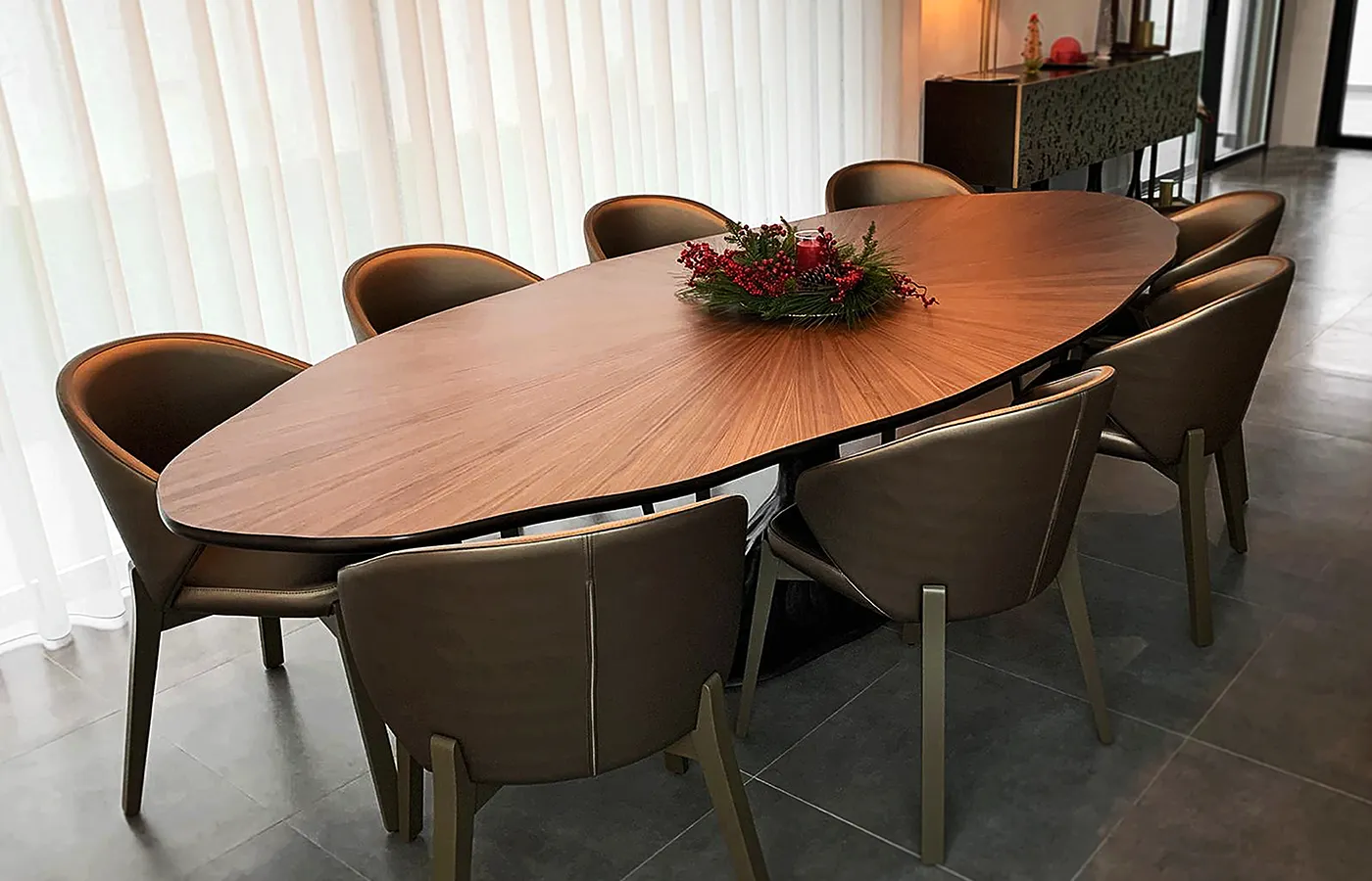 Dining area with Bonsai dining table in brass color and burr walnut top with chairs