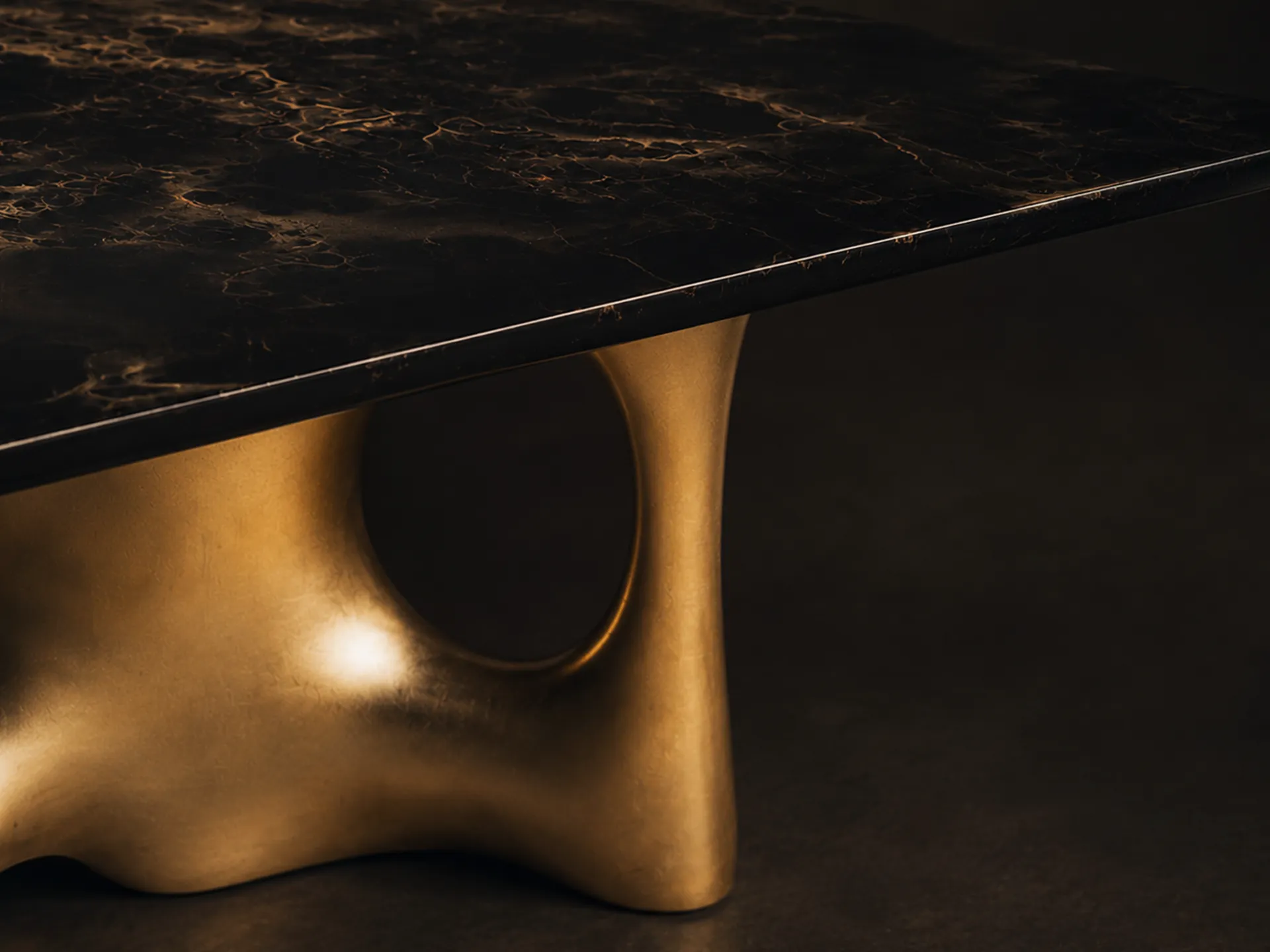 Close-up view of the artistic painting in golden tones on the Cosmic dining table