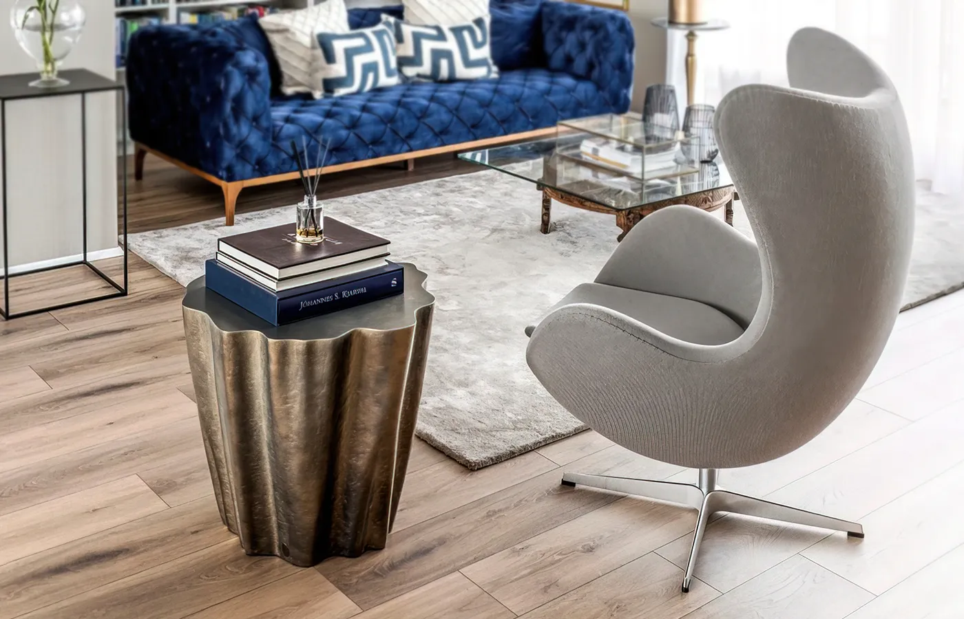 Living room setting with Gaia side table in brass color next to armchair