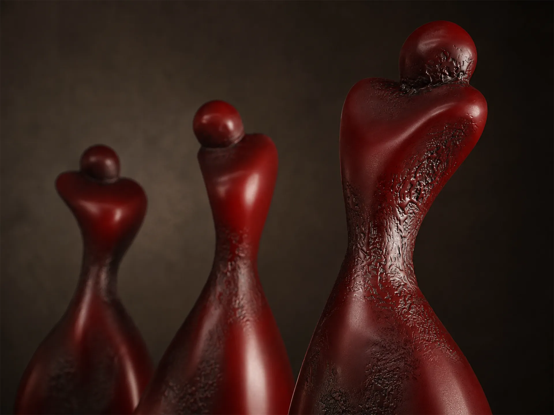 Detailed view of the Gémeas set of sculptures, highlighting their unique textured red finish