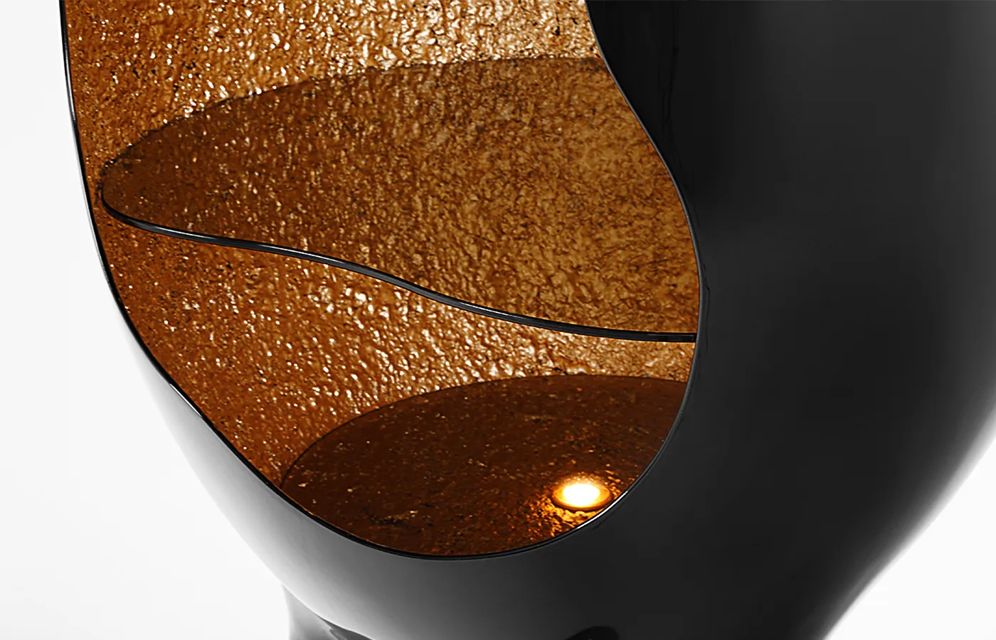 Close-up view of the Orion display case in high-gloss black with a textured gold leaf interior