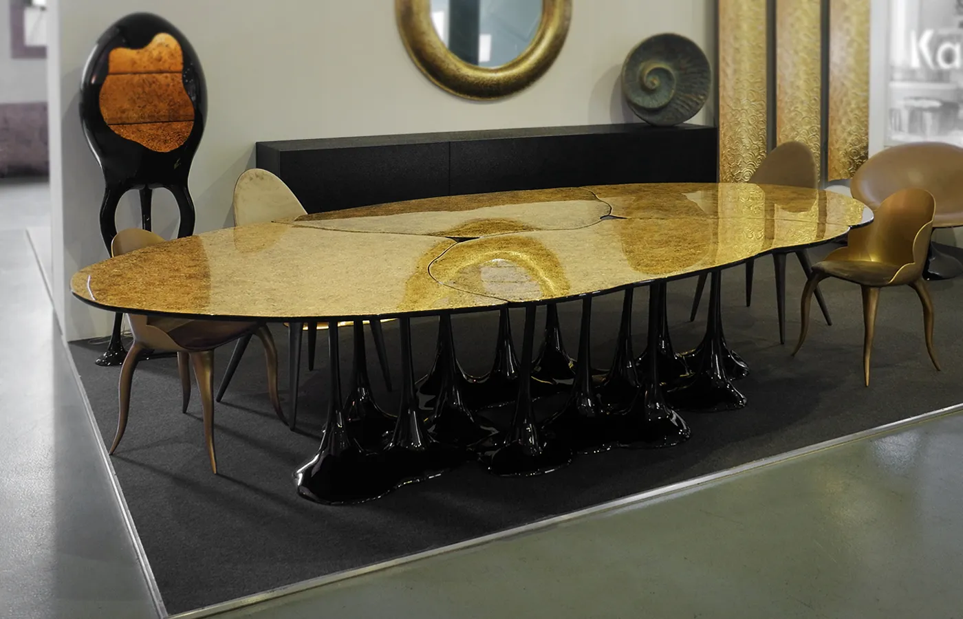 Pangea dining table on display with Karpa furniture and textured gold leaf finish