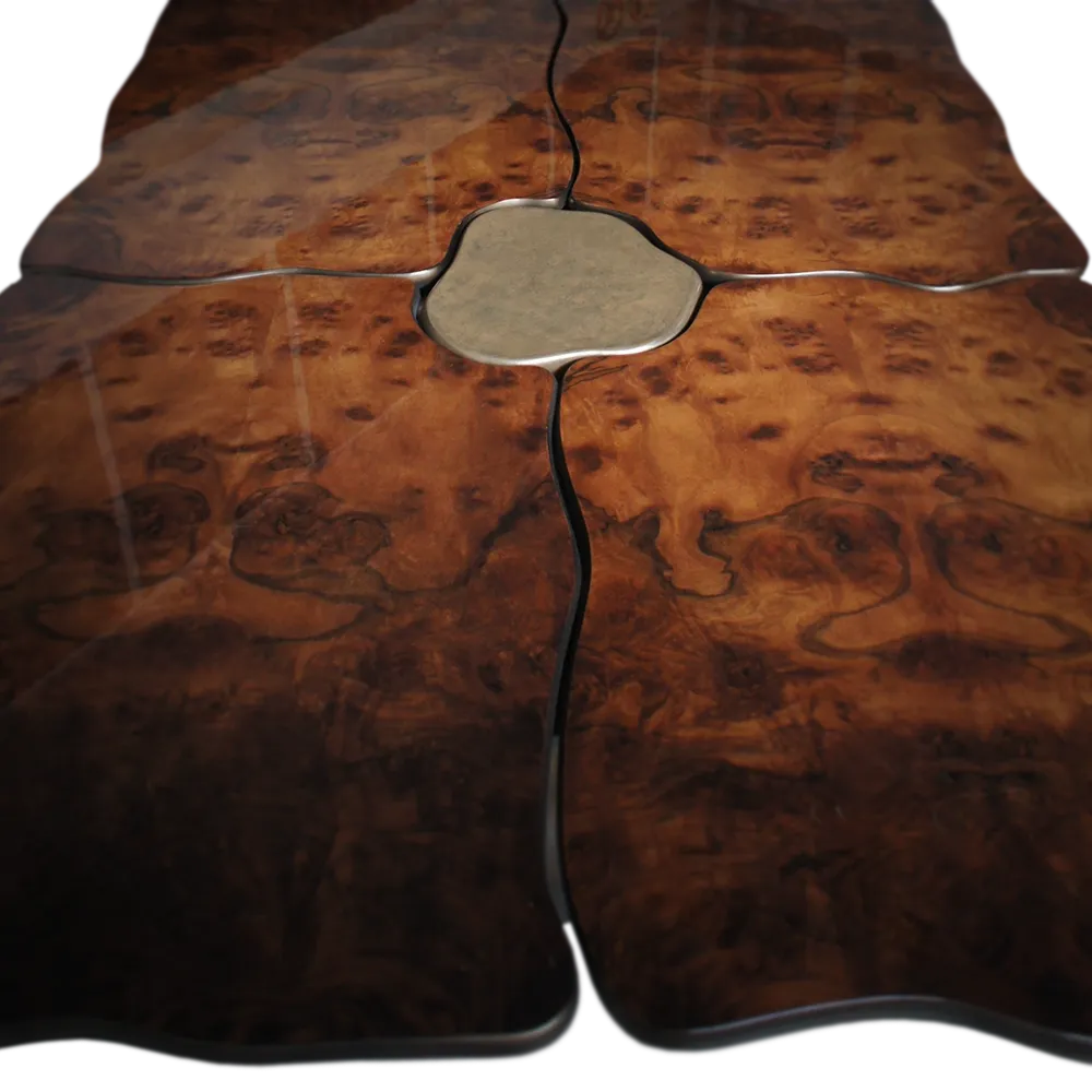 Detailed view of the Sigma dining table top in walnut root with its wavy cuts