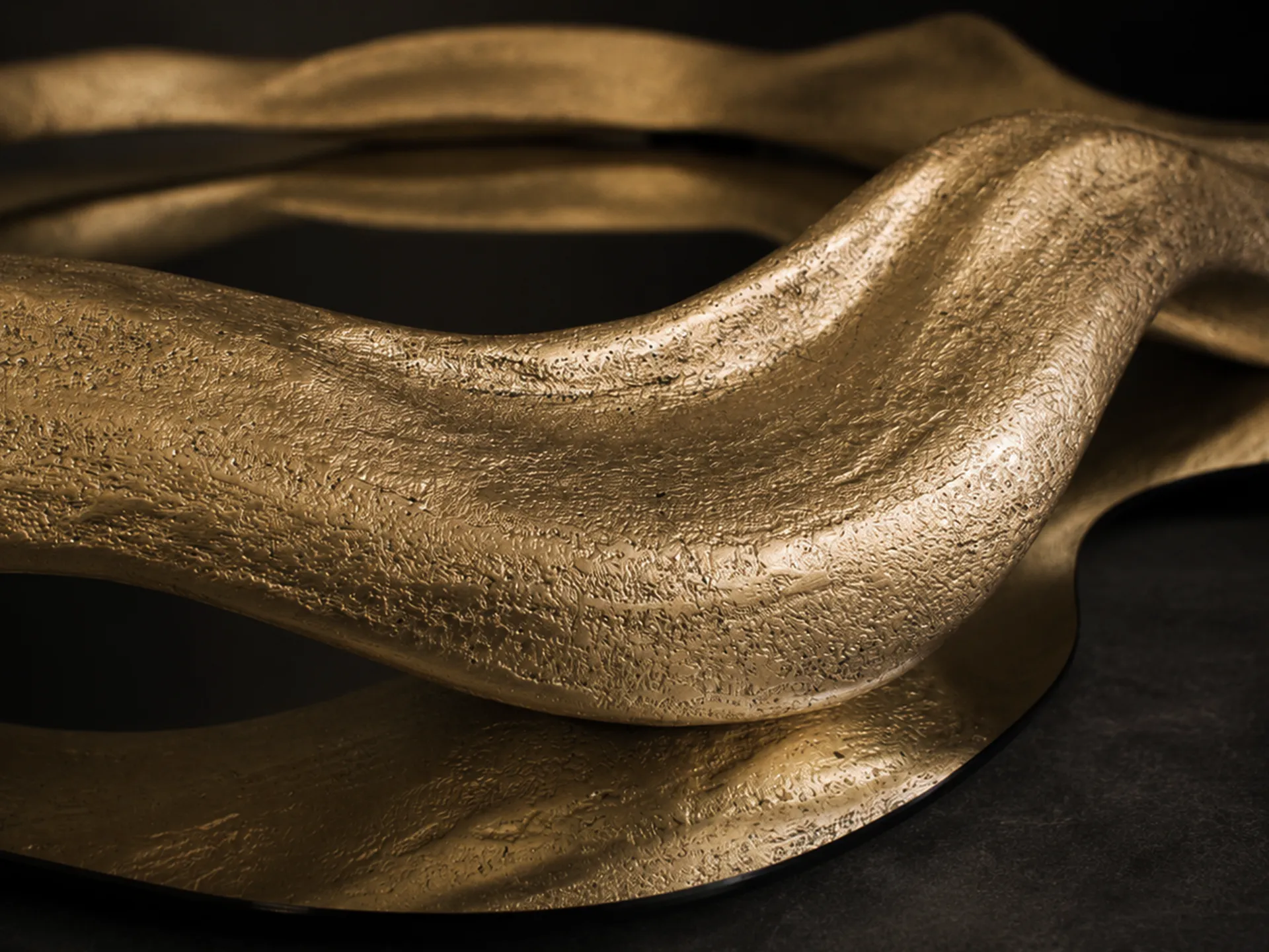 Detailed view of the round Twisted mirror, highlighting its textured gold leaf finish