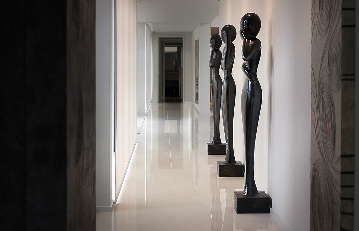 Hallway with set of Wisdom sculptures in lead color