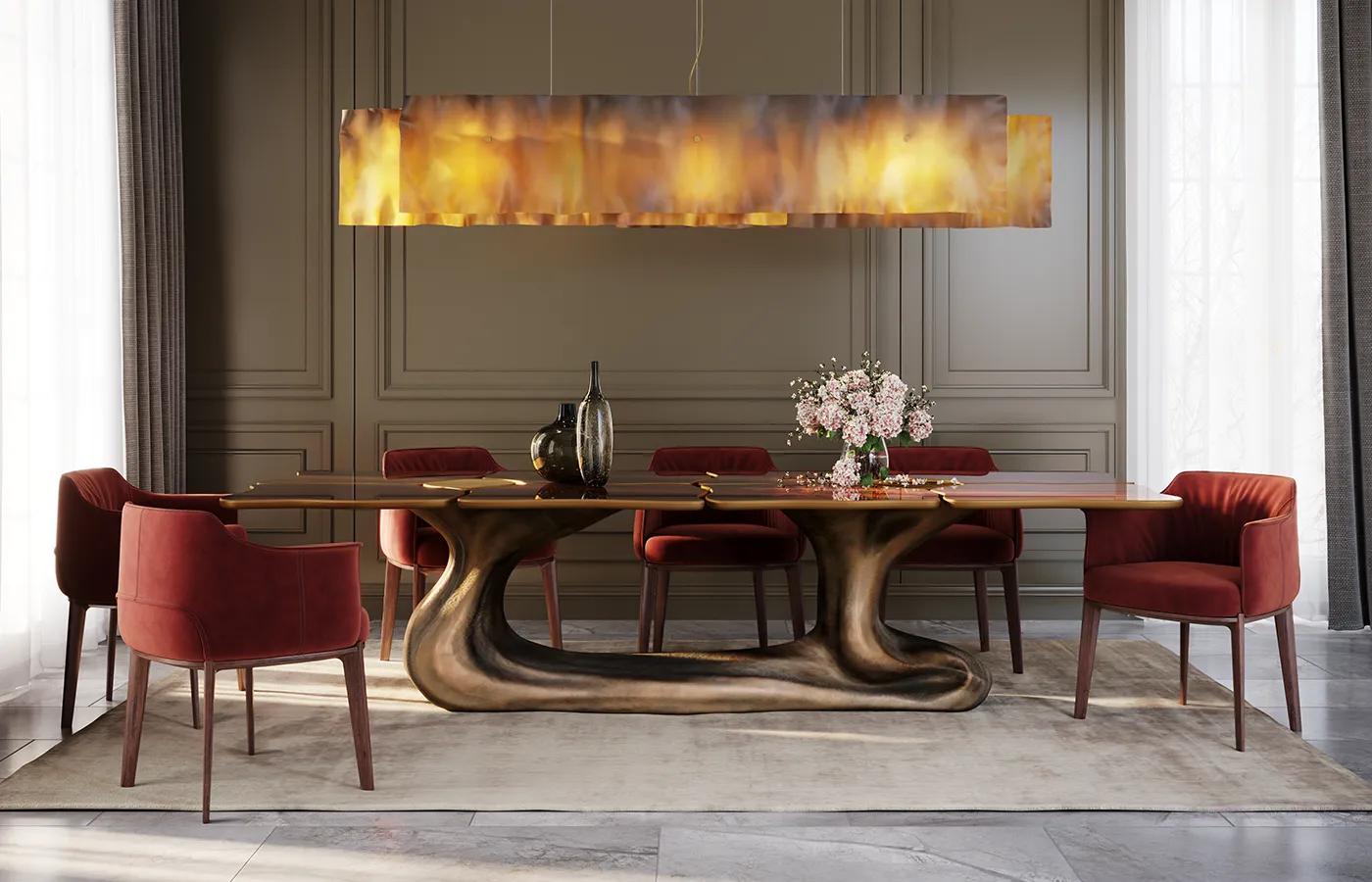 Sigma dining table with brass-colored base and walnut root veneer top, set in an elegant room with red chairs.