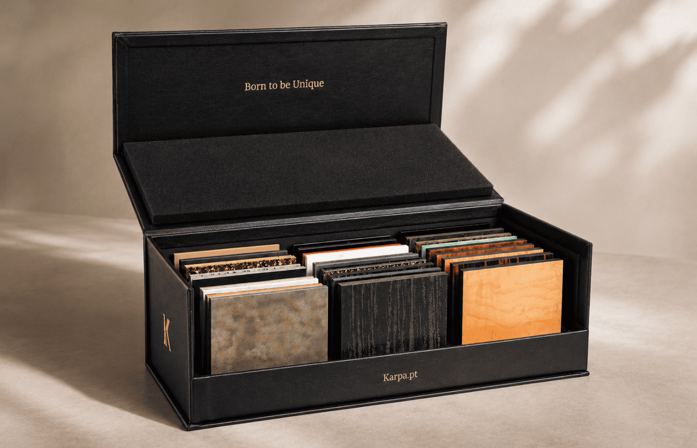 Karpa's sample box featuring different colors and textures, including metallic, black, and wood-tone options for customizing furniture