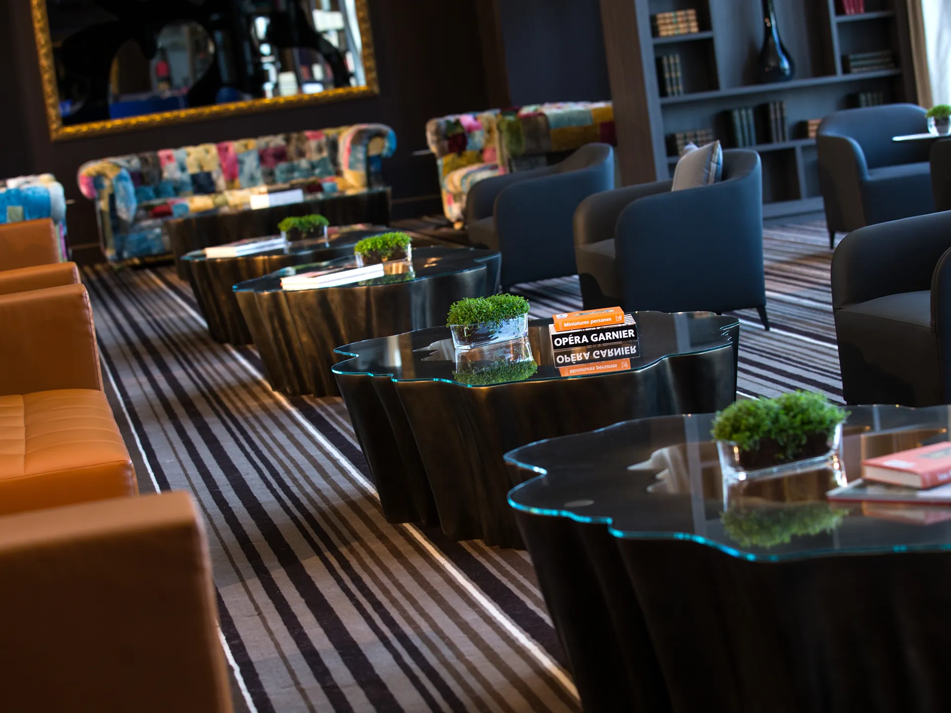 Conjunto de mesas de centro Gaia em cor bronze num espaço lounge de hotel luxuoso